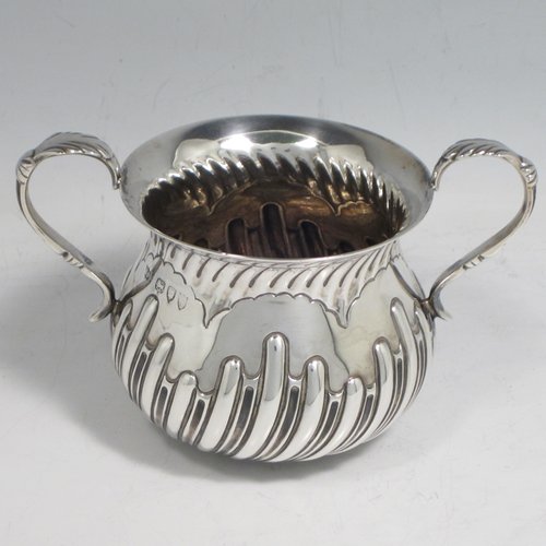 Antique Victorian sterling silver porringer, having a round baluster body with hand-chased half swirl-fluted decoration, two scroll side handles, and sitting on a flat base. Made by Robert Pringle of London in 1893. The dimensions of this fine hand-made silver porringer are height 8 cms (3 inches), spread across arms 12 cms (4.75 inches), and it weighs approx. 115g (3.7 troy ounces).   