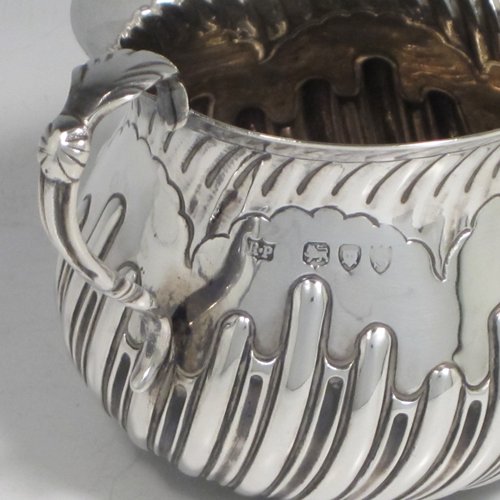 Antique Victorian sterling silver porringer, having a round baluster body with hand-chased half swirl-fluted decoration, two scroll side handles, and sitting on a flat base. Made by Robert Pringle of London in 1893. The dimensions of this fine hand-made silver porringer are height 8 cms (3 inches), spread across arms 12 cms (4.75 inches), and it weighs approx. 115g (3.7 troy ounces).   