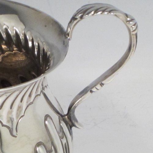 Antique Victorian sterling silver porringer, having a round baluster body with hand-chased half swirl-fluted decoration, two scroll side handles, and sitting on a flat base. Made by Robert Pringle of London in 1893. The dimensions of this fine hand-made silver porringer are height 8 cms (3 inches), spread across arms 12 cms (4.75 inches), and it weighs approx. 115g (3.7 troy ounces).   