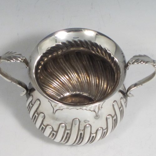 Antique Victorian sterling silver porringer, having a round baluster body with hand-chased half swirl-fluted decoration, two scroll side handles, and sitting on a flat base. Made by Robert Pringle of London in 1893. The dimensions of this fine hand-made silver porringer are height 8 cms (3 inches), spread across arms 12 cms (4.75 inches), and it weighs approx. 115g (3.7 troy ounces).   