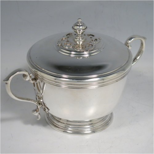 A Sterling Silver porringer, having a round baluster body, with two scroll side handles, a pull-off cover with cast finial, with applied cut-card work decoration around the handles & finial, and all sitting on a collet foot. Made by Haviland of London in 1971. The dimensions of this fine hand-made silver porringer are height 11 cms (4.3 inches), spread across arms 16 cms (6.25 inches), and it weighs approx. 361g (11.6 troy ounces).