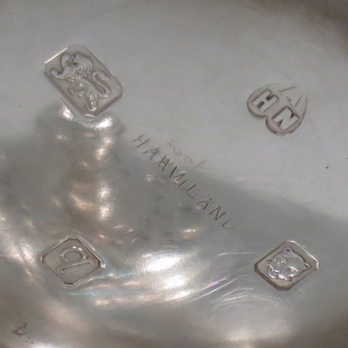 A Sterling Silver porringer, having a round baluster body, with two scroll side handles, a pull-off cover with cast finial, with applied cut-card work decoration around the handles & finial, and all sitting on a collet foot. Made by Haviland of London in 1971. The dimensions of this fine hand-made silver porringer are height 11 cms (4.3 inches), spread across arms 16 cms (6.25 inches), and it weighs approx. 361g (11.6 troy ounces).