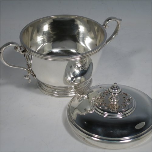 A Sterling Silver porringer, having a round baluster body, with two scroll side handles, a pull-off cover with cast finial, with applied cut-card work decoration around the handles & finial, and all sitting on a collet foot. Made by Haviland of London in 1971. The dimensions of this fine hand-made silver porringer are height 11 cms (4.3 inches), spread across arms 16 cms (6.25 inches), and it weighs approx. 361g (11.6 troy ounces).