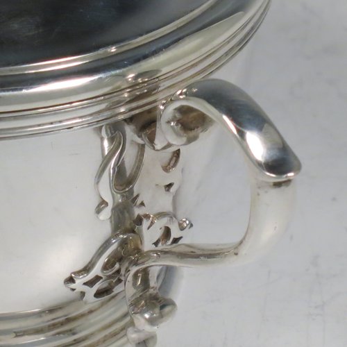 A Sterling Silver porringer, having a round baluster body, with two scroll side handles, a pull-off cover with cast finial, with applied cut-card work decoration around the handles & finial, and all sitting on a collet foot. Made by Haviland of London in 1971. The dimensions of this fine hand-made silver porringer are height 11 cms (4.3 inches), spread across arms 16 cms (6.25 inches), and it weighs approx. 361g (11.6 troy ounces).