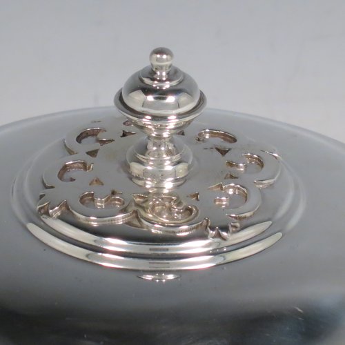 A Sterling Silver porringer, having a round baluster body, with two scroll side handles, a pull-off cover with cast finial, with applied cut-card work decoration around the handles & finial, and all sitting on a collet foot. Made by Haviland of London in 1971. The dimensions of this fine hand-made silver porringer are height 11 cms (4.3 inches), spread across arms 16 cms (6.25 inches), and it weighs approx. 361g (11.6 troy ounces).