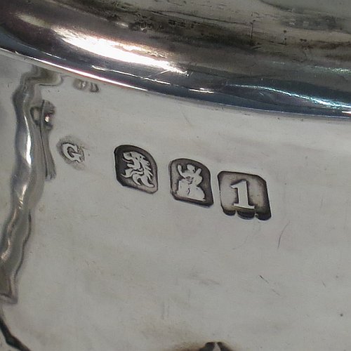 An Antique Edwardian Britannia Standard Silver porringer, having a round baluster body with a hand-hammered finish and hand-chased anthemion and floral decoration, a lift-off lid with matching floral work and a cast round finial, and two cast floral handles. Made by George Fox of London in 1906. The dimensions of this fine hand-made antique Britannia silver porringer and lid are height 11.5 cms (4.5 inches), spread across arms 16 cms (6.3 inches), and it weighs approx. 370g (12 troy ounces).    