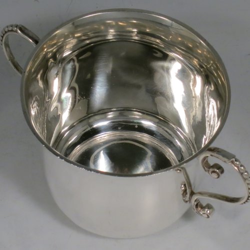 An Antique Victorian Sterling Silver porringer, having a plain round baluster body, two scroll side handles with beaded decoration, and sitting on a flat base. Made by Francis Higgins of London in 1897. The dimensions of this fine hand-made antique silver porringer are height 7.5 cms (3 inches), spread across arms 14 cms (5.5 inches), and it weighs approx. 163g (5.3 troy ounces).   