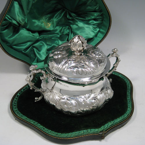 Antique Edwardian sterling silver porringer, having a round baluster body with hand-chased floral decoration, a gold-gilt interior, a lift-off lid with cast floral finial, and two cast figural handles, all in original satin and velvet-lined presentation box. Made by Carrington and Co., of London in 1907. The dimensions of this fine hand-made silver porringer and lid are height 14 cms (5.5 inches), spread across arms 19 cms (7.5 inches), and it weighs approx. 553g (17.8 troy ounces).   