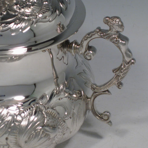 Antique Edwardian sterling silver porringer, having a round baluster body with hand-chased floral decoration, a gold-gilt interior, a lift-off lid with cast floral finial, and two cast figural handles, all in original satin and velvet-lined presentation box. Made by Carrington and Co., of London in 1907. The dimensions of this fine hand-made silver porringer and lid are height 14 cms (5.5 inches), spread across arms 19 cms (7.5 inches), and it weighs approx. 553g (17.8 troy ounces).   