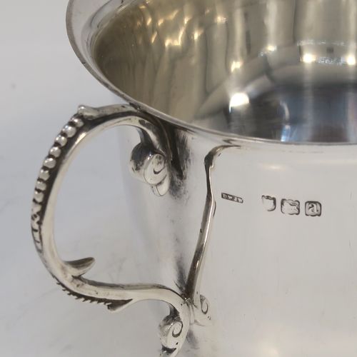 A handsome Antique Victorian Sterling Silver porringer, having a plain round bellied body, two scroll side handles with beaded decoration, and sitting on a flat base. This elegant silver porringer was made by D. and J. Welby of London in 1896. The dimensions of this fine hand-made antique silver porringer are height 7.5 cms (3 inches), spread across arms 14.5 cms (5.75 inches), and it weighs approx. 153g (5 troy ounces).  