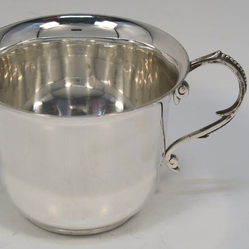 A handsome Antique Victorian Sterling Silver porringer, having a plain round bellied body, two scroll side handles with beaded decoration, and sitting on a flat base. This elegant silver porringer was made by D. and J. Welby of London in 1896. The dimensions of this fine hand-made antique silver porringer are height 7.5 cms (3 inches), spread across arms 14.5 cms (5.75 inches), and it weighs approx. 153g (5 troy ounces).  