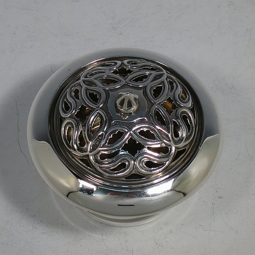 An Antique Edwardian Sterling Silver pot pourri holder, having a plain round body with tapering sides, a pull-off pierced grill with cast finial, a gold-gilt interior, and all sitting on a flat base. Made by Samuel Jacob of London in 1907. The dimensions of this fine hand-made antique silver pot-pourri holder are diameter 8 cms (3.25 inches), height 7 cms (2.75 inches), and it weighs approx. 86g (2.8 troy ounces).    