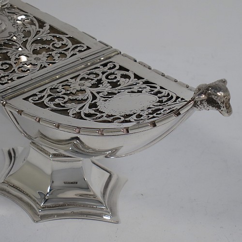 A very pretty Antique Sterling Silver pot pourri holder, or ecclesiastical Thurible incense burner, having an unusual boat-shaped body with a hand-pierced floral style cover, with one side hinged with a cast octagonal ball finial, two cast lambs-head side-handles, and all sitting on a spreading hexafoil pedestal foot. Made by Nathan and Hayes of Chester in 1912. The dimensions of this fine hand-made antique silver pot-pourri holder, or ecclesiastical Thurible incense burner, are length 19 cms (7.5 inches), width 6.5 cms (2.5 inches), height 8 cms (3 inches), and it weighs approx. 195g (6.3 troy ounces) 