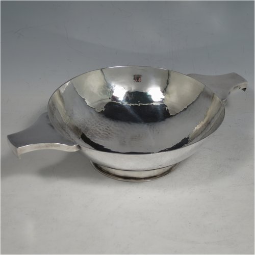 A Sterling Silver large Scottish quaich (being a  replica of a Charles I example dated 1626), having a very plain round body with hand-hammered finish, with two side handles, and sitting on a collet foot. Made by Robert Sawers  of Edinburgh in 1926. The dimensions of this fine hand-made silver quaich are diameter of body 15 cms (6 inches), height 5 cms (2 inches), and it weighs approx. 310g (10 troy ounces).