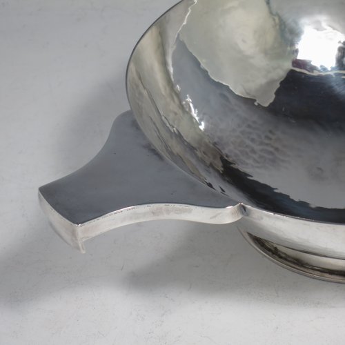 A Sterling Silver large Scottish quaich (being a  replica of a Charles I example dated 1626), having a very plain round body with hand-hammered finish, with two side handles, and sitting on a collet foot. Made by Robert Sawers  of Edinburgh in 1926. The dimensions of this fine hand-made silver quaich are diameter of body 15 cms (6 inches), height 5 cms (2 inches), and it weighs approx. 310g (10 troy ounces).