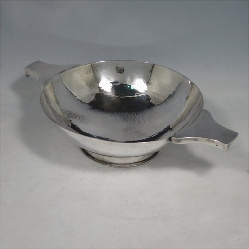 A Sterling Silver large Scottish quaich (being a  replica of a Charles I example dated 1626), having a very plain round body with hand-hammered finish, with two side handles, and sitting on a collet foot. Made by Robert Sawers  of Edinburgh in 1926. The dimensions of this fine hand-made silver quaich are diameter of body 15 cms (6 inches), height 5 cms (2 inches), and it weighs approx. 310g (10 troy ounces).