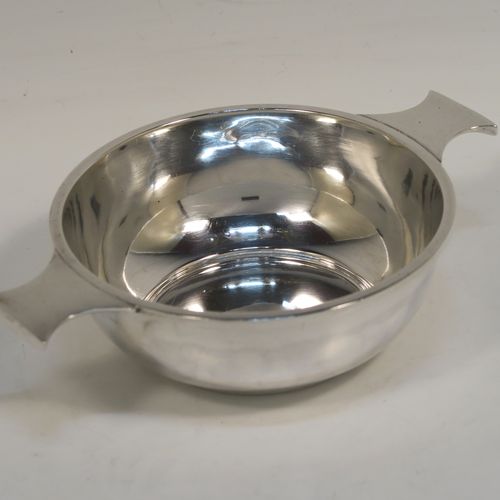 An elegant Antique Sterling Silver quaich, having a very plain round body, with two side handles, and sitting on a flat base. This handsome antique silver quaich was made by Cook, Holland and Co., of Birmingham in 1920. The dimensions of this fine hand-made silver quaich are diameter of body 11 cms (4.3 inches), height 4 cms (1.5 inches), and it weighs approx. 154g (5 troy ounces).  