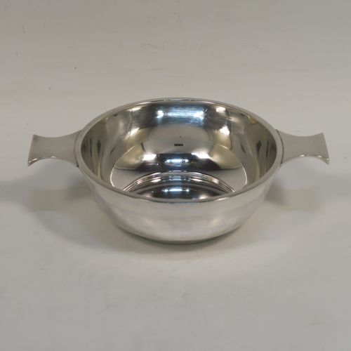 An elegant Antique Sterling Silver quaich, having a very plain round body, with two side handles, and sitting on a flat base. This handsome antique silver quaich was made by Cook, Holland and Co., of Birmingham in 1920. The dimensions of this fine hand-made silver quaich are diameter of body 11 cms (4.3 inches), height 4 cms (1.5 inches), and it weighs approx. 154g (5 troy ounces).  