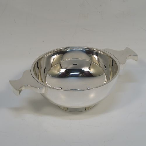 A handsome Scottish Sterling Silver Quaich, having a very plain round body, with two side handles, and sitting on a collet foot. This elegant silver Quaich was made by Davidson, Henderson, and Sorley of Glasgow in 1933. The dimensions of this fine hand-made silver Scottish Quaich are diameter of body 9 cms (3.5 inches), height 4 cms (1.5 inches), and it weighs approx. 116g (3.7 troy ounces).   