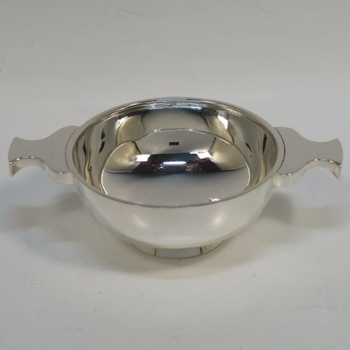 A handsome Scottish Sterling Silver Quaich, having a very plain round body, with two side handles, and sitting on a collet foot. This elegant silver Quaich was made by Davidson, Henderson, and Sorley of Glasgow in 1933. The dimensions of this fine hand-made silver Scottish Quaich are diameter of body 9 cms (3.5 inches), height 4 cms (1.5 inches), and it weighs approx. 116g (3.7 troy ounces).   