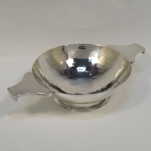 A large and very handsome Scottish Sterling Silver Quaich, having a very plain round body with hand-hammered decoration, with two cast side handles, and sitting on a pedestal foot. This elegant silver Quaich was made by Robert Sawyers of Edinburgh in 1932, and is a replica of an early Charles I Quaich from 1626. The dimensions of this fine hand-made Scottish Silver Quaich are diameter of body 15 cms (6 inches), height 5 cms (2 inches), and it weighs approx. 314g (10 troy ounces).   