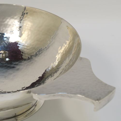 A large and very handsome Scottish Sterling Silver Quaich, having a very plain round body with hand-hammered decoration, with two cast side handles, and sitting on a pedestal foot. This elegant silver Quaich was made by Robert Sawyers of Edinburgh in 1932, and is a replica of an early Charles I Quaich from 1626. The dimensions of this fine hand-made Scottish Silver Quaich are diameter of body 15 cms (6 inches), height 5 cms (2 inches), and it weighs approx. 314g (10 troy ounces).   