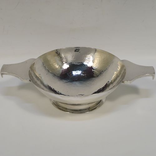 A large and very handsome Scottish Sterling Silver Quaich, having a very plain round body with hand-hammered decoration, with two cast side handles, and sitting on a pedestal foot. This elegant silver Quaich was made by Robert Sawyers of Edinburgh in 1932, and is a replica of an early Charles I Quaich from 1626. The dimensions of this fine hand-made Scottish Silver Quaich are diameter of body 15 cms (6 inches), height 5 cms (2 inches), and it weighs approx. 314g (10 troy ounces).   