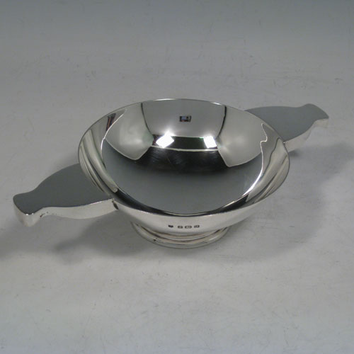 Sterling silver quaich, having a very plain round body, with two side handles, sitting on a pedestal foot. Made by Charles S. Green and Co., of Birmingham in 1933. The dimensions of this fine hand-made silver quaich are diameter of body 11 cms (4.25 inches), height 4 cms (1.5 inches), and it weighs approx. 165g (5.3 troy ounces).    