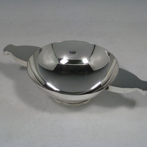 Sterling silver quaich, having a very plain round body, with two side handles, sitting on a pedestal foot. Made by Charles S. Green and Co., of Birmingham in 1933. The dimensions of this fine hand-made silver quaich are diameter of body 11 cms (4.25 inches), height 4 cms (1.5 inches), and it weighs approx. 165g (5.3 troy ounces).    