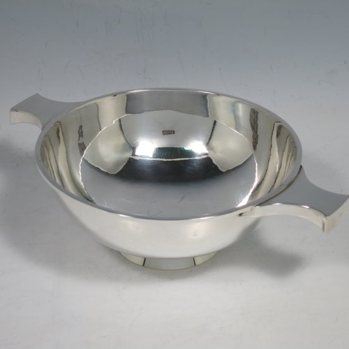 A Sterling Silver Scottish quaich, having a very plain round body, with two side handles, sitting on a collet foot. Made by Hamilton & Inches of Edinburgh in 1977. The dimensions of this fine hand-made silver quaich are diameter of body 13 cms (5 inches), height 5 cms (2 inches), and it weighs approx. 217g (7 troy ounces).    