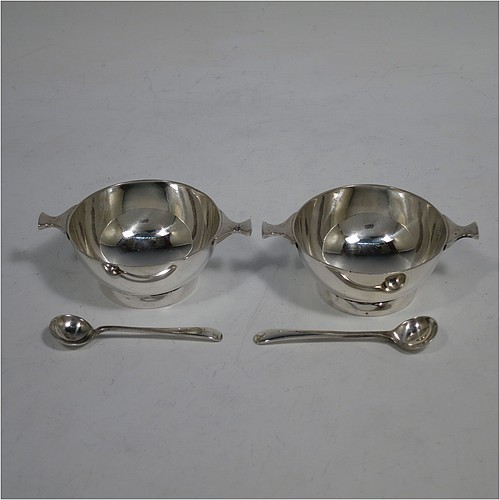 A handsome pair of Scottish Sterling Silver small quaichs, having very plain round bodies, with two side handles, and sitting on collet feet, together with two matching sterling silver Old English pattern spoons. All in their original cream satin and blue velvet-lined presentation box. The quaichs made by Wilson and Sharp of Edinburgh in 1921. The dimensions of these fine hand-made silver quaichs are diameter of body 5.5 cms (2.25 inches), height 2.5 cms (1 inch), and they weigh a total of approx. 90g (3 troy ounces).    