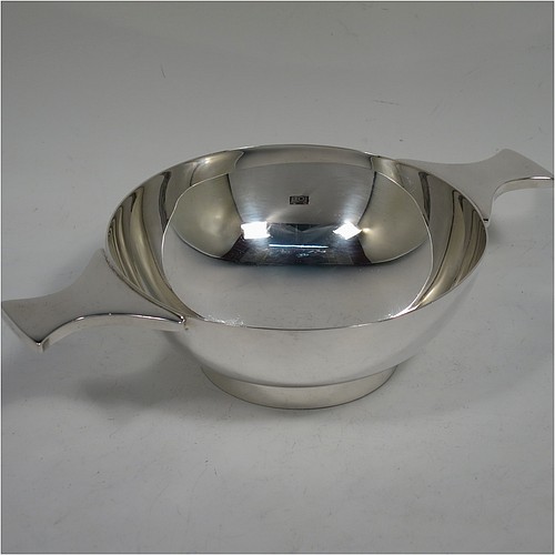 A very handsome and large Sterling Silver Scottish quaich, having a very plain round body, with two side handles, and sitting on a collet foot. Made by Mappin and Webb of Edinburgh in 1997. The dimensions of this fine hand-made silver quaich are diameter of body 13 cms (5 inches), height 5 cms (2 inches), and it weighs approx. 318g (10 troy ounces).    