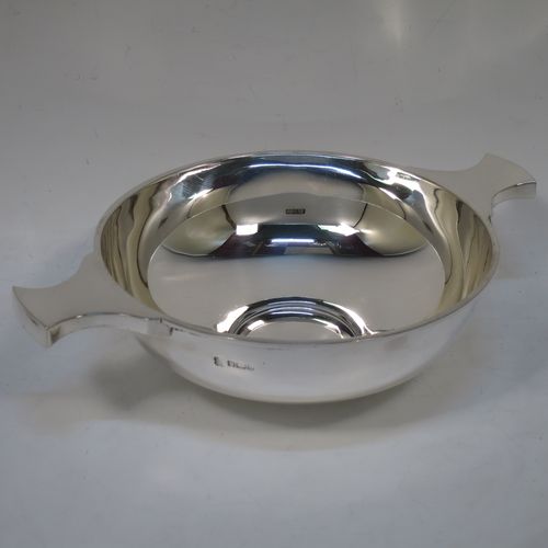 A handsome and large Antique Edwardian Sterling Silver Quaich, having a very plain round body, with two side handles, and sitting on a collet foot. This elegant antique silver Quaich was made by Martin Hall and Co. Ltd., of Sheffield in 1905. The dimensions of this fine hand-made antique silver Quaich are diameter of body 16.6 cms (6.5 inches), height 6 cms (2.3 inches), and it weighs approx. 350g (11 troy ounces).  