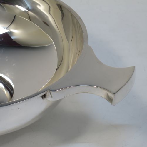 A handsome and large Antique Edwardian Sterling Silver Quaich, having a very plain round body, with two side handles, and sitting on a collet foot. This elegant antique silver Quaich was made by Martin Hall and Co. Ltd., of Sheffield in 1905. The dimensions of this fine hand-made antique silver Quaich are diameter of body 16.6 cms (6.5 inches), height 6 cms (2.3 inches), and it weighs approx. 350g (11 troy ounces).  