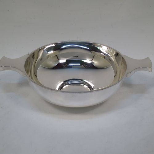 A handsome and large Antique Edwardian Sterling Silver Quaich, having a very plain round body, with two side handles, and sitting on a collet foot. This elegant antique silver Quaich was made by Martin Hall and Co. Ltd., of Sheffield in 1905. The dimensions of this fine hand-made antique silver Quaich are diameter of body 16.6 cms (6.5 inches), height 6 cms (2.3 inches), and it weighs approx. 350g (11 troy ounces).  