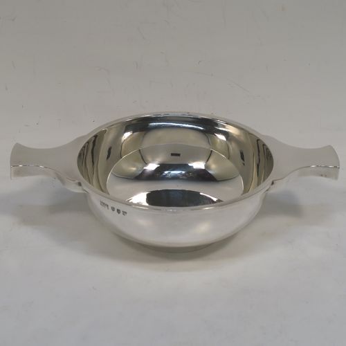 A very handsome Sterling Silver Scottish quaich, having a very plain round body, with two side handles, and sitting on a collet foot. This elegant silver quaich was made by Mackay and Chisholm of Edinburgh in 1927. The dimensions of this fine hand-made silver quaich are diameter of body 11.5 cms (4.5 inches), height 5 cms (2 inches), and it weighs approx. 192g (6.2 troy ounces).