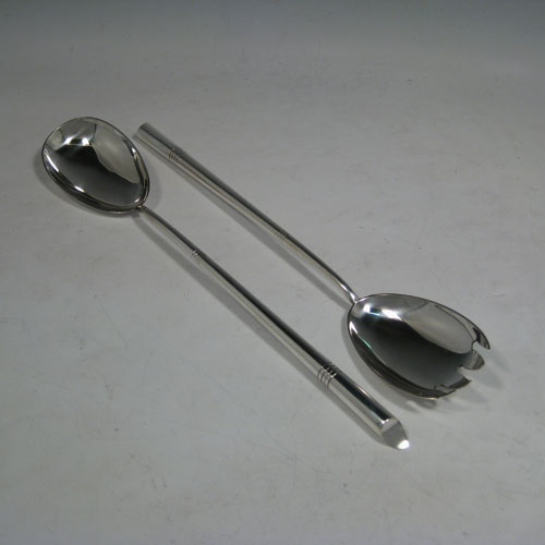    Antique Victorian sterling silver pair of Arts and Crafts salad servers, having very plain bodies, with oval bowls, tapering handles with bands of reeded engraving. Made by Henry Wilkinson of Sheffield in 1898. The length of these silver salad servers are 28 cms (11 inches), and the total weight is approx. 126g (4.1 troy ounces). 