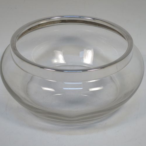 A handsome Antique Sterling Silver and hand-cut crystal salad bowl, having a plain round body with a plain applied silver rim, and all sitting on a flat base. Made by Henry Atkins of Sheffield in 1914. The dimensions of this fine hand-made antique silver and crystal salad bowl are diameter 23 cms (9 inches), and height 10 cms (4 inches).   