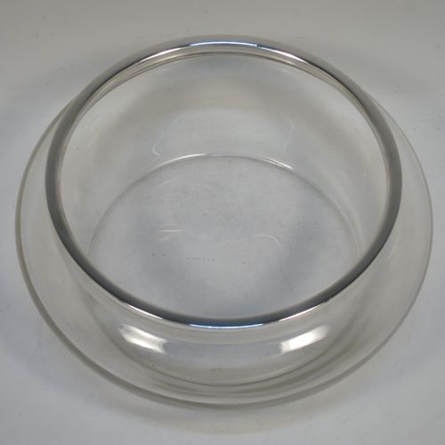 A handsome Antique Sterling Silver and hand-cut crystal salad bowl, having a plain round body with a plain applied silver rim, and all sitting on a flat base. Made by Henry Atkins of Sheffield in 1914. The dimensions of this fine hand-made antique silver and crystal salad bowl are diameter 23 cms (9 inches), and height 10 cms (4 inches).   