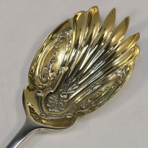 A very pretty pair of Antique Edwardian Sterling Silver salad servers, having plain Old English pattern handles, with hand-chased scalloped and gold-gilt bowls. This beautiful antique silver pair of salad serving spoons was made by Marple and Co., of Sheffield in 1902. The dimensions of these hand-made silver salad servers are length 21.5 cms (8.5 inches), and they weigh a total of 125g (4 troy ounces.   