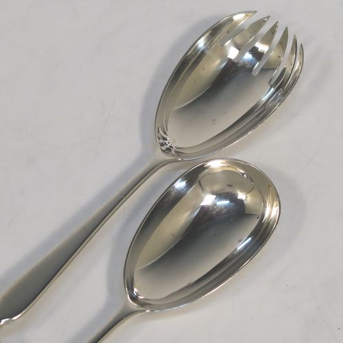 A pretty pair of Antique Victorian Sterling Silver and crystal handled salad servers, having very plain bodies with oval bowls, and hand-cut crystal handles. This beautiful antique silver and crystal salad serving set was made by Angel and Savoury of London in 1886. The length of these silver and crystal salad servers are 30.5 cms (12 inches).   