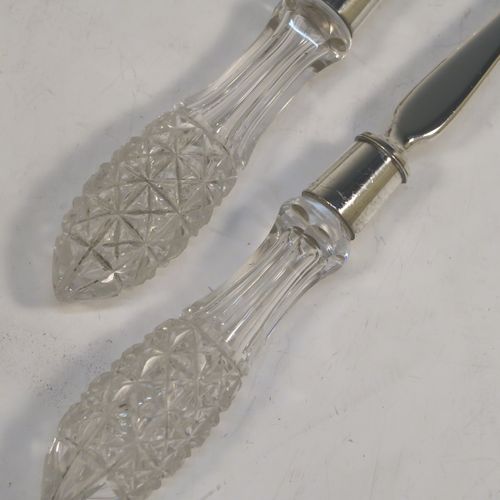 A pretty pair of Antique Victorian Sterling Silver and crystal handled salad servers, having very plain bodies with oval bowls, and hand-cut crystal handles. This beautiful antique silver and crystal salad serving set was made by Angel and Savoury of London in 1886. The length of these silver and crystal salad servers are 30.5 cms (12 inches).   