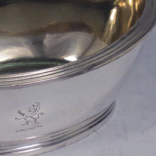 An Antique Georgian Sterling Silver pair of salt cellars, in an oval bath-shaped style, having plain oval bodies, with gold-gilt interiors, applied reeded borders, all sitting on reeded collet feet. Made by either Henry Nutting OR Hannah Northcote of London in 1804. The dimensions of these fine hand-made antique silver salt cellars are length 9.5 cms (3.75 inches), width 6.5 cms (2.5 inches), height 4 cms (1.5 inches), and they weigh a total of approx. 185g (6 troy ounces). Please note that both salt cellars are part-crested.