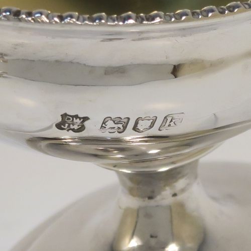 A very handsome Antique Edwardian Sterling Silver pair of salt cellars, in a boat-shaped style, having plain oval bodies, with gold-gilt interiors, applied  gadroon borders, and all sitting on oval pedestal feet. These elegant antique silver salt dishes were made by D. and J. Welby of London in 1905. The dimensions of these fine hand-made antique silver salt cellars are length 10 cms (4 inches), width 6.5 cms (2.5 inches), height 6.5 cms (2.5 inches), and they weigh a total of approx. 162g (5.2 troy ounces).   