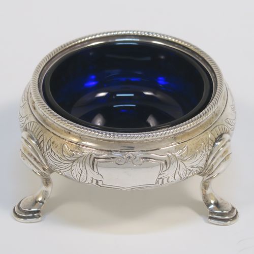 A very pretty pair of Antique Victorian Sterling Silver cauldron salt cellars, having round bellied bodies with hand-chased floral and scroll decoration, with applied rope-twist borders, blue glass liners, and sitting on three cast hoof feet. These beautiful antique silver salt cellars were made by Francis Dexter of London in 1847. The dimensions of these fine hand-made antique silver salt cellars are diameter 6.5 cms (2.5 inches), height 4 cms (1.5 inches), and they weigh a total of approx. 151g (4.9 troy ounces).   