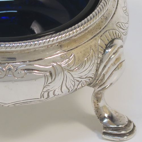 A very pretty pair of Antique Victorian Sterling Silver cauldron salt cellars, having round bellied bodies with hand-chased floral and scroll decoration, with applied rope-twist borders, blue glass liners, and sitting on three cast hoof feet. These beautiful antique silver salt cellars were made by Francis Dexter of London in 1847. The dimensions of these fine hand-made antique silver salt cellars are diameter 6.5 cms (2.5 inches), height 4 cms (1.5 inches), and they weigh a total of approx. 151g (4.9 troy ounces).   