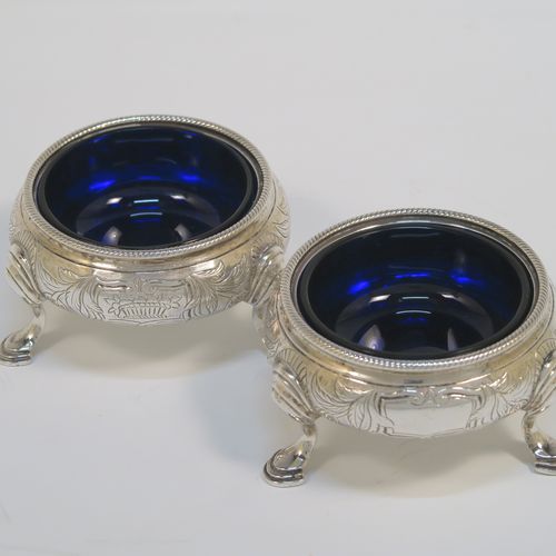 A very pretty pair of Antique Victorian Sterling Silver cauldron salt cellars, having round bellied bodies with hand-chased floral and scroll decoration, with applied rope-twist borders, blue glass liners, and sitting on three cast hoof feet. These beautiful antique silver salt cellars were made by Francis Dexter of London in 1847. The dimensions of these fine hand-made antique silver salt cellars are diameter 6.5 cms (2.5 inches), height 4 cms (1.5 inches), and they weigh a total of approx. 151g (4.9 troy ounces).   