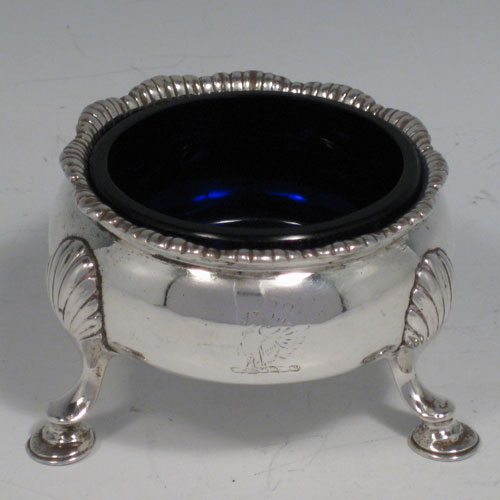 A very handsome Antique Georgian Sterling Silver set of four cauldron salt cellars having plain round bellied bodies, with applied gadroon top borders, and siting on three cast hoof feet. These elegant silver salt cellars were made by David Hennell I of London in 1759. The dimension of this antique silver set of four salt cellars are diameter 7 cms (2.75 inches), height 4.5 cms (1.75 inches), and with a total weight approx. 10 troy ounces (310g). Please note that these salts have engraved crests.