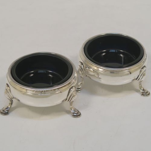 A very handsome Antique Georgian Sterling Silver pair of George III cauldron salt cellars, having plain round bodies, with rope-twist borders, blue glass liners, and sitting on three cast hoof feet. These elegant antique silver cauldron salt cellars were made in London in 1768. The dimensions of these fine hand-made silver salt cellars are diameter 6 cms (2.3 inches), height 3.5 cms (1.3 inches), and they weigh a total of approx. 80g (2.6 troy ounces)   