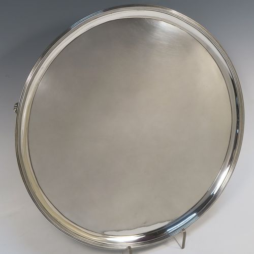 A very handsome Antique Georgian Sterling Silver salver, having an applied reeded border, a plain ground, and sitting on four cast reeded feet. This beautiful antique silver salver was made by John Hutson of London in 1792. The dimensions of this fine hand-made antique silver salver are diameter 35.5 cms (14 inches), and it weighs approx. 1,214g (39 troy ounces).  